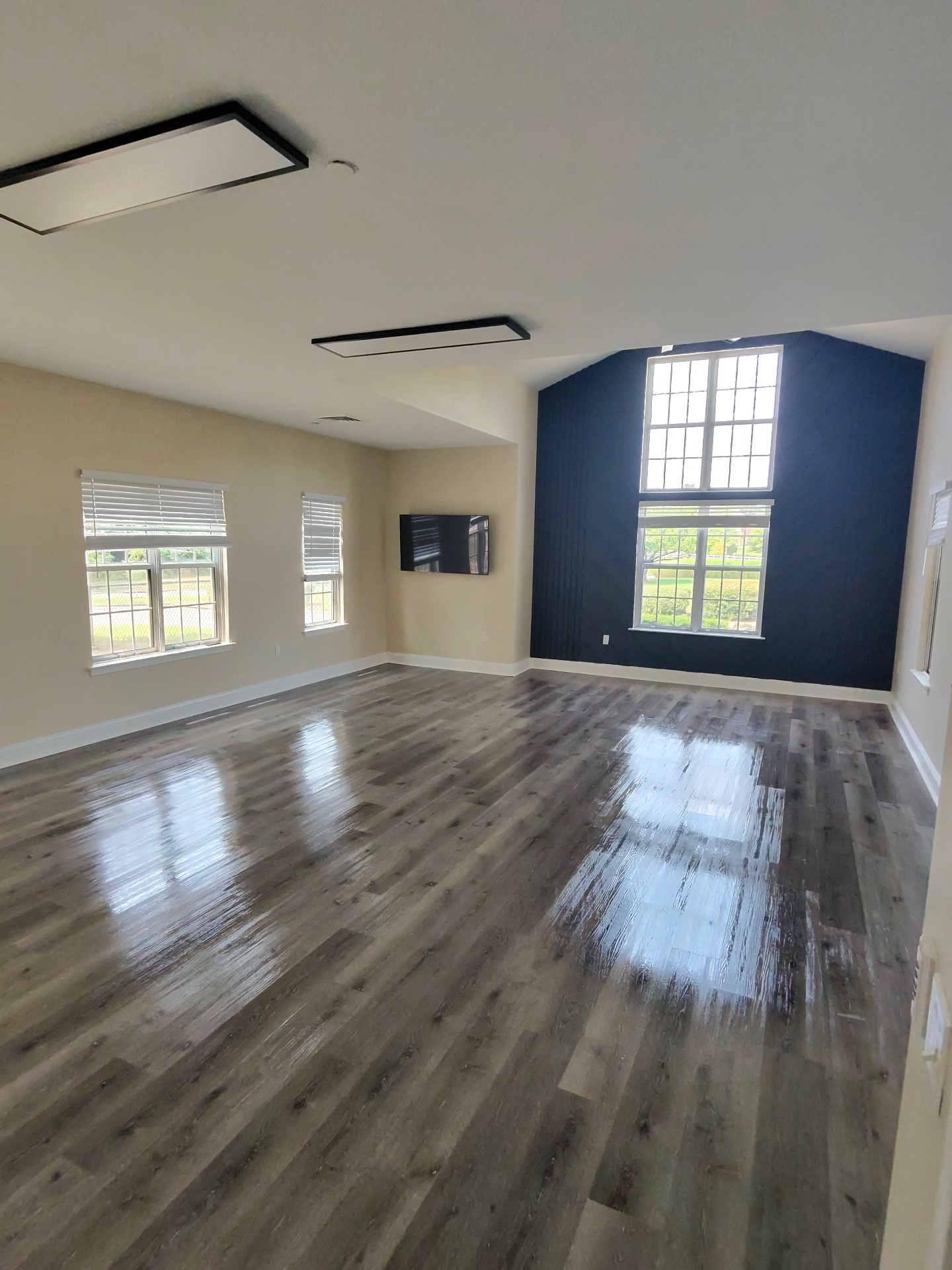 Spacious living room with gleaming hardwood floors after a professional cleaning