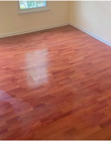 Hardwood floor in an empty room polished to a glossy shine