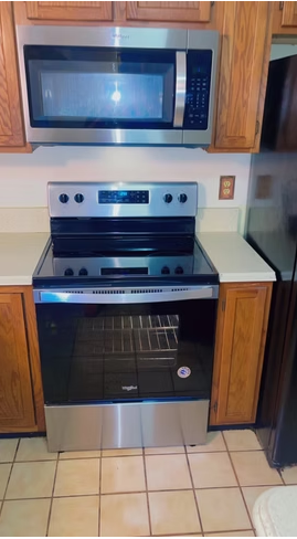 Stainless steel range and microwave cleaned in a kitchen