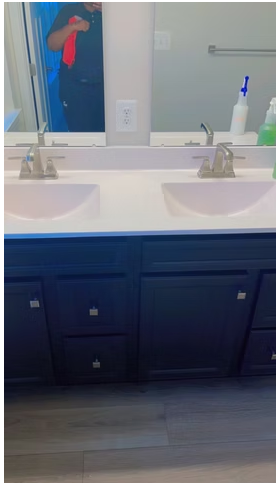 Double vanity with polished sinks, faucets and a streak-free mirror