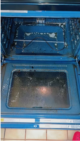 Oven interior covered in baked-on grease before cleaning