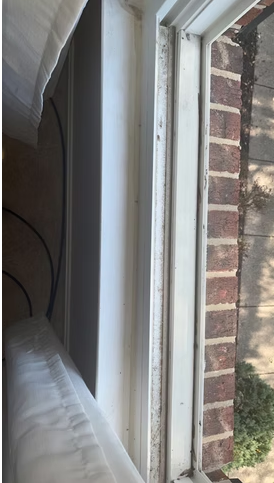 Window sill cleaned along a brick exterior wall
