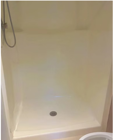 Clean shower stall with spotless walls and drain